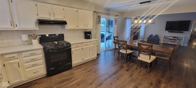 kitchen with decorative light fixtures, white cabinets, dark wood-type flooring, and black gas range