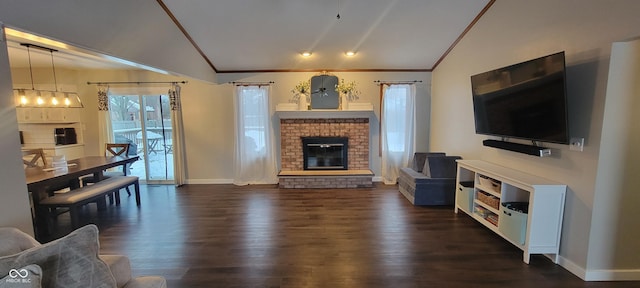 living room featuring lofted ceiling, a brick fireplace, and plenty of natural light