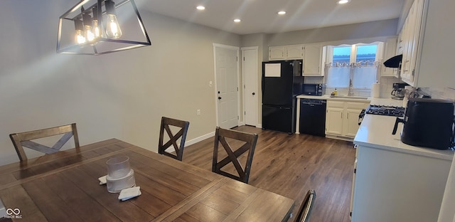 dining space featuring sink and dark hardwood / wood-style floors