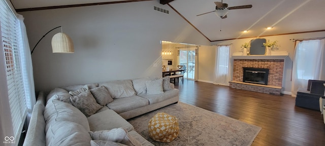 living room featuring a brick fireplace, dark wood-type flooring, ceiling fan, and vaulted ceiling with beams