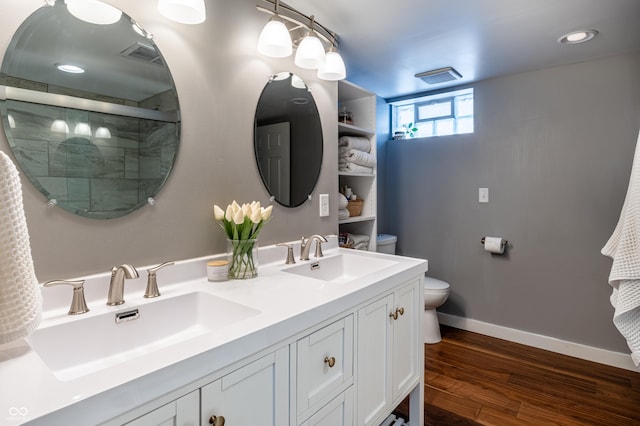 bathroom with hardwood / wood-style floors, a shower with shower door, vanity, and toilet