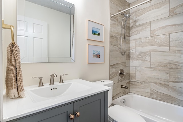 full bathroom with tiled shower / bath combo, vanity, and toilet