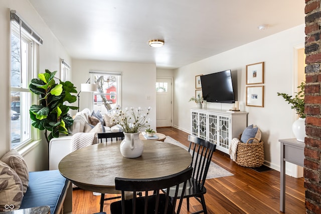 dining room featuring dark hardwood / wood-style flooring and a wealth of natural light