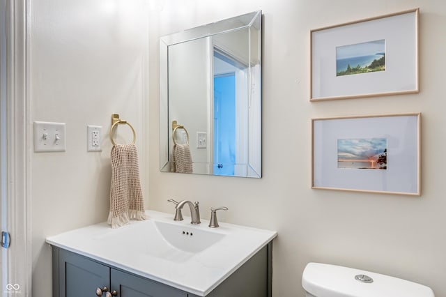 bathroom with toilet and vanity