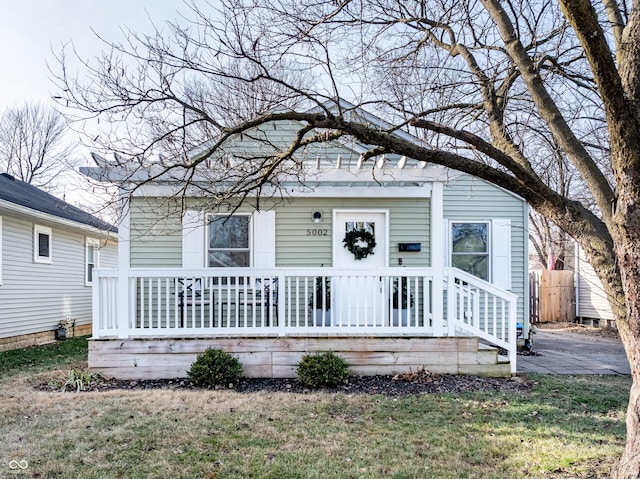 bungalow-style home with a front yard