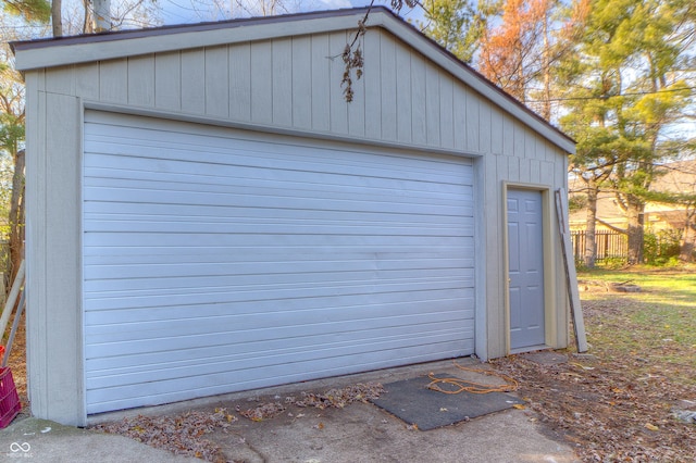 detached garage featuring fence