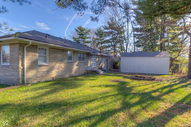 view of yard featuring an outbuilding, a storage shed, and entry steps