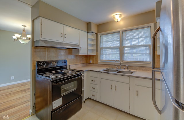 kitchen with black electric range, decorative backsplash, freestanding refrigerator, a sink, and under cabinet range hood