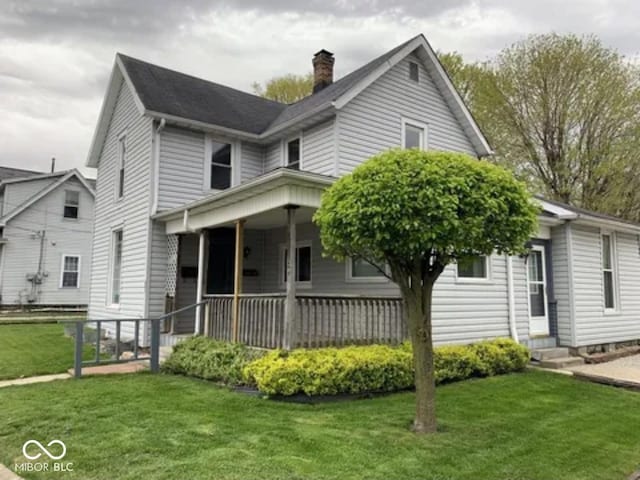 view of front facade with covered porch and a front lawn