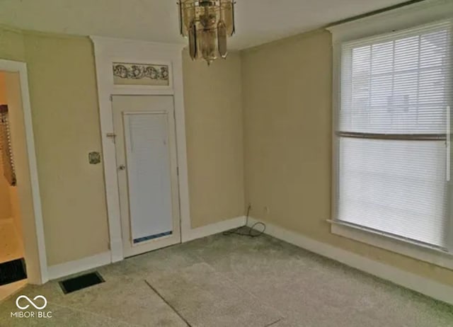 unfurnished dining area featuring light colored carpet