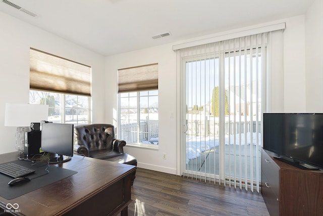 office space featuring dark wood-style floors, visible vents, and baseboards