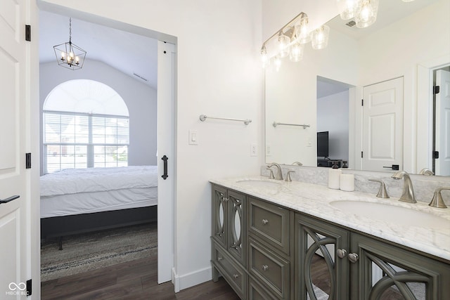 full bathroom featuring double vanity, wood finished floors, ensuite bathroom, and a sink