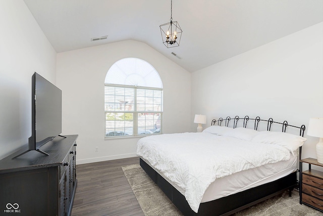 bedroom with visible vents, lofted ceiling, a notable chandelier, and dark wood finished floors