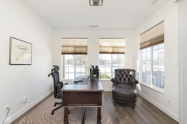 office space with dark wood finished floors and baseboards