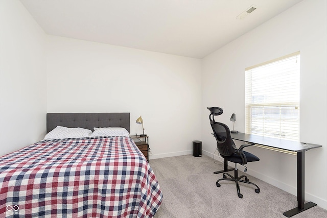 bedroom with carpet, visible vents, and baseboards