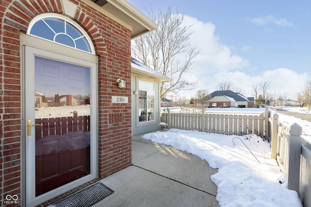 view of snow covered property entrance