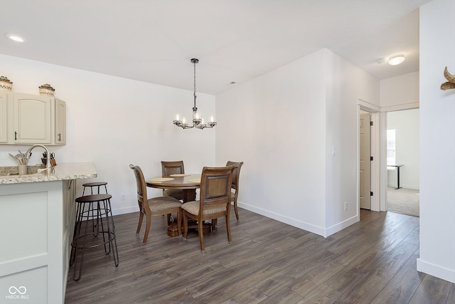 dining room with dark wood-style floors, baseboards, and a chandelier