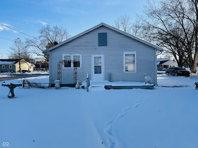 view of snow covered back of property