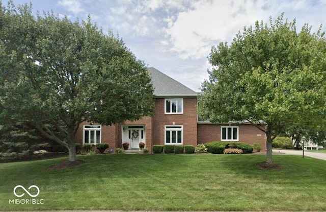 colonial inspired home with a front yard