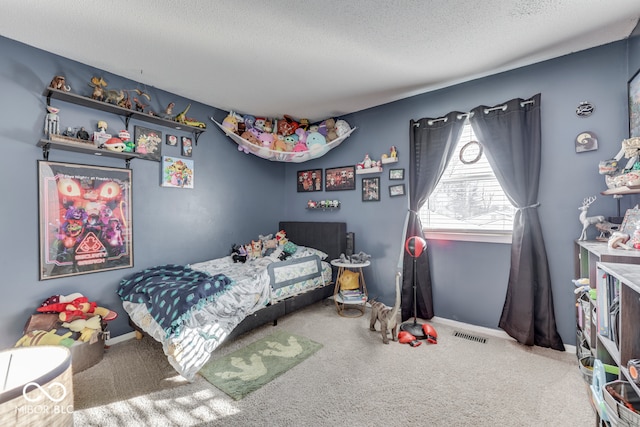 carpeted bedroom with a textured ceiling