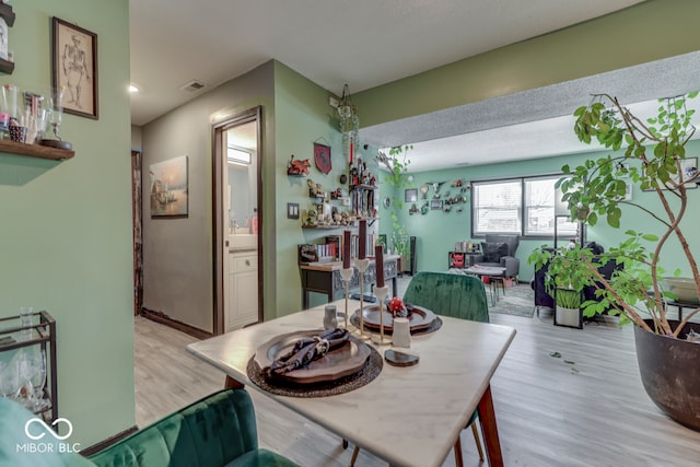 dining space with light hardwood / wood-style floors