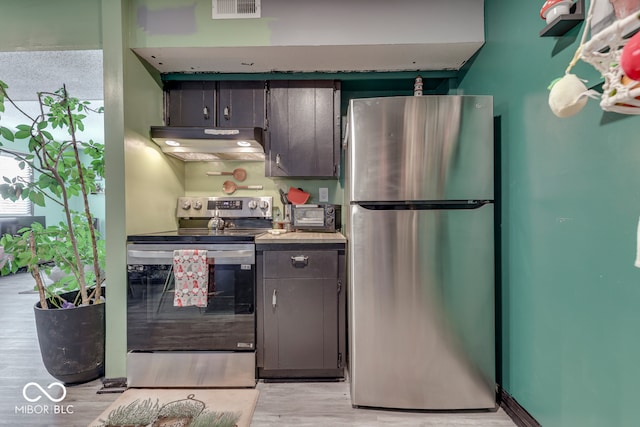 kitchen with stainless steel appliances and light wood-type flooring