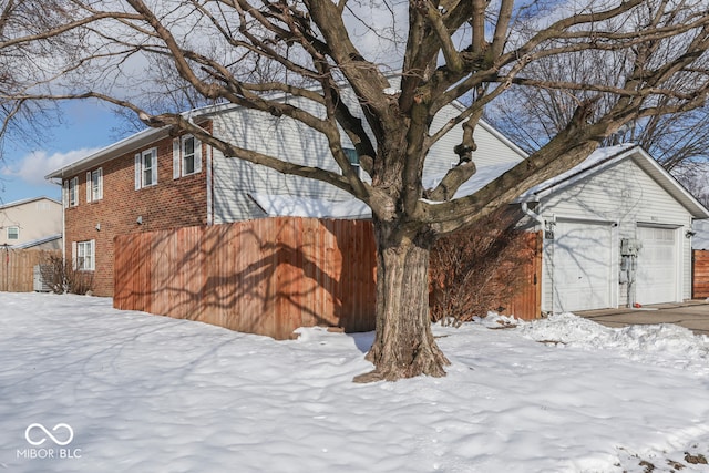 view of snow covered exterior with a garage