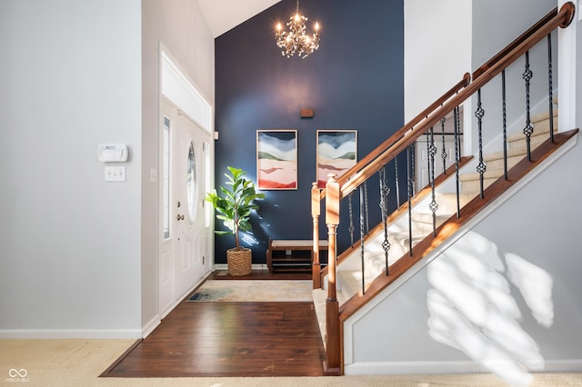 foyer entrance featuring a notable chandelier and a high ceiling