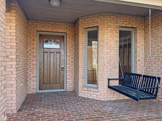 entrance to property with brick siding