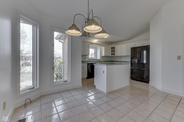 kitchen with visible vents, black appliances, a kitchen island, glass insert cabinets, and white cabinetry