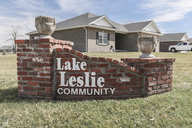 community sign featuring a lawn