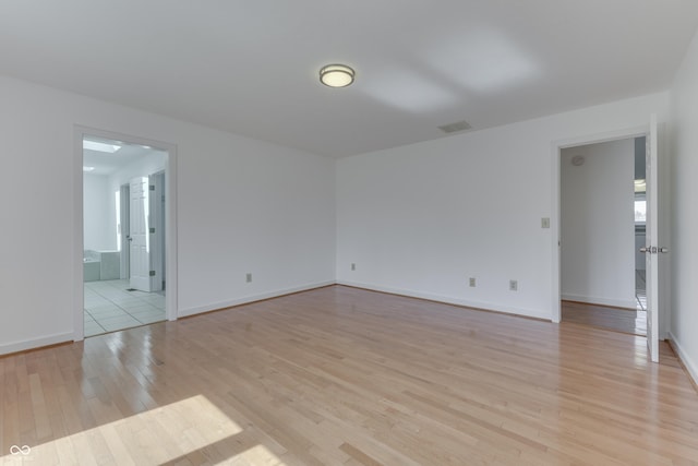 unfurnished room with visible vents, baseboards, and light wood-style flooring