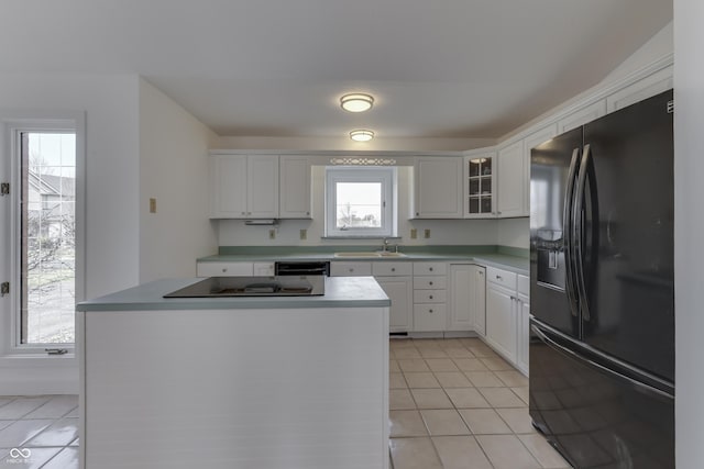 kitchen featuring white cabinetry, black appliances, light tile patterned flooring, and light countertops