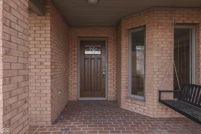 property entrance with brick siding