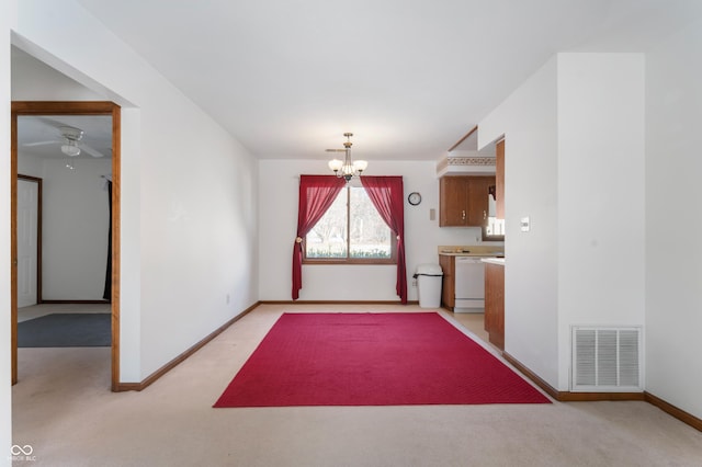 interior space featuring light colored carpet and an inviting chandelier