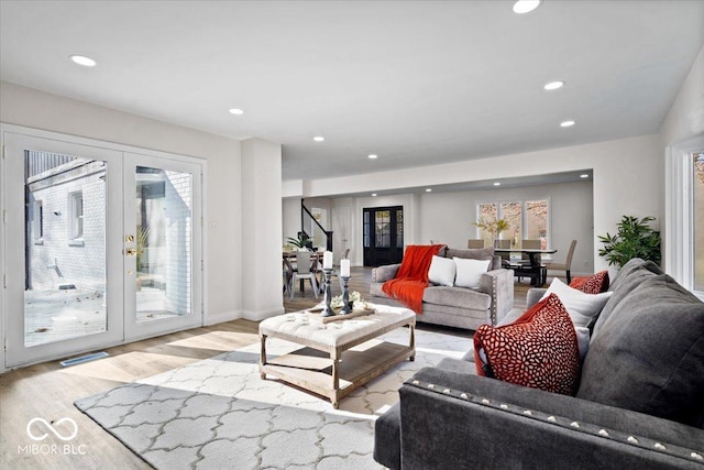 living room featuring french doors and light hardwood / wood-style floors