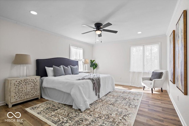 bedroom with ornamental molding, ceiling fan, and hardwood / wood-style floors