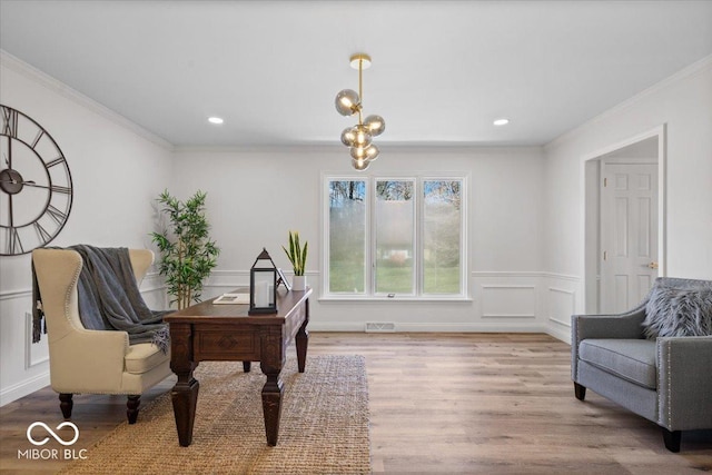 office area featuring a notable chandelier, ornamental molding, and light wood-type flooring