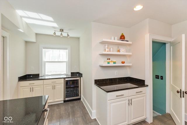 kitchen featuring white cabinets and beverage cooler