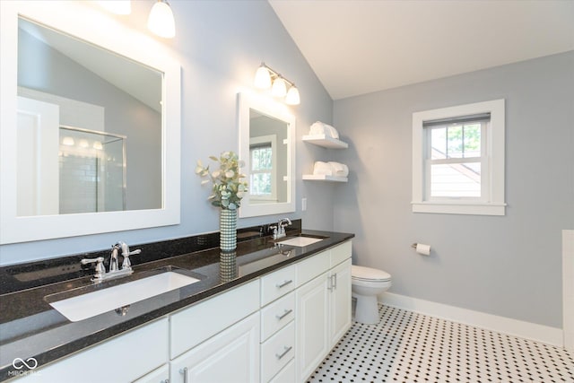 bathroom with toilet, a shower with door, vanity, and vaulted ceiling