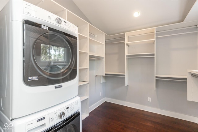 laundry room with stacked washing maching and dryer and dark hardwood / wood-style floors