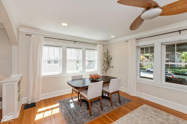 dining space with light hardwood / wood-style floors, ceiling fan, and crown molding