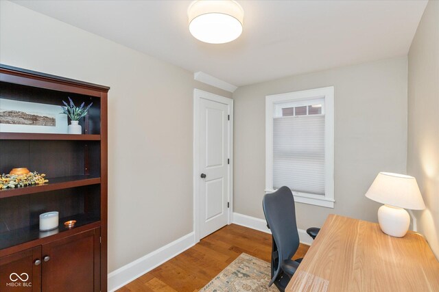 office with light hardwood / wood-style flooring