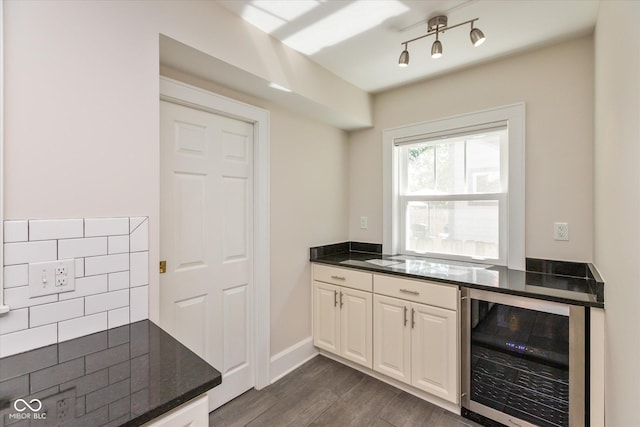 kitchen with dark hardwood / wood-style flooring, beverage cooler, and white cabinetry