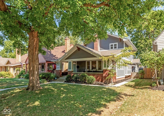 craftsman inspired home featuring covered porch and a front lawn