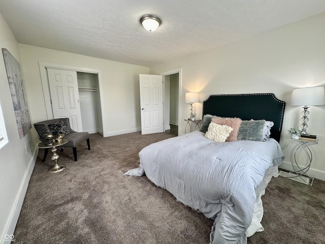 carpeted bedroom featuring a closet and a textured ceiling