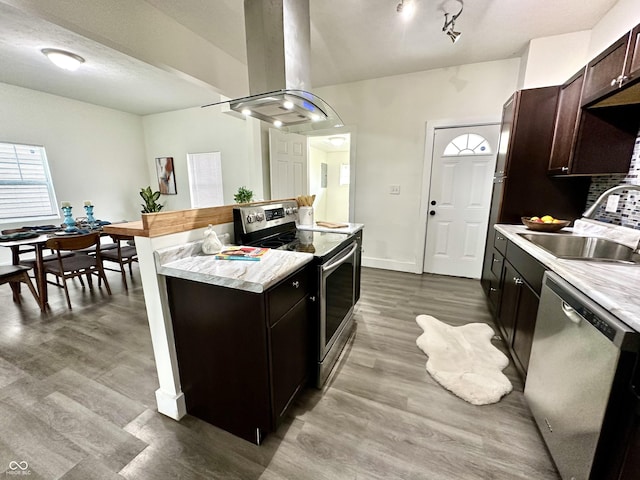 kitchen featuring stainless steel appliances, sink, light wood-type flooring, island exhaust hood, and dark brown cabinetry