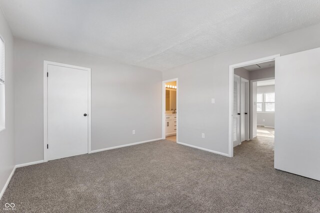 carpeted spare room featuring a textured ceiling