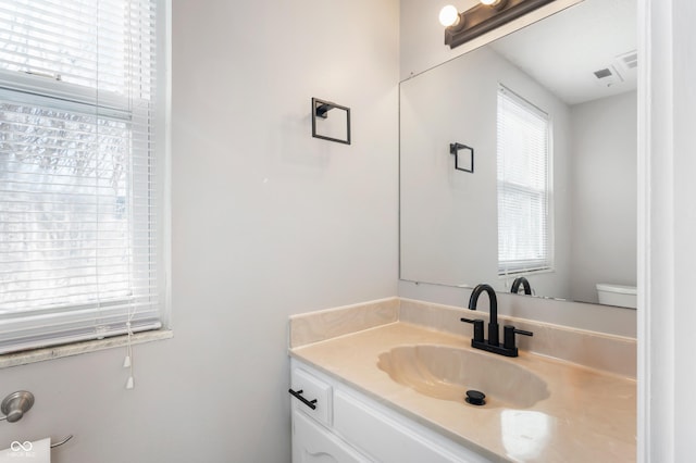 bathroom featuring toilet and vanity