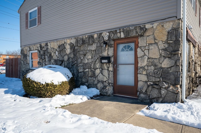 view of snow covered property entrance